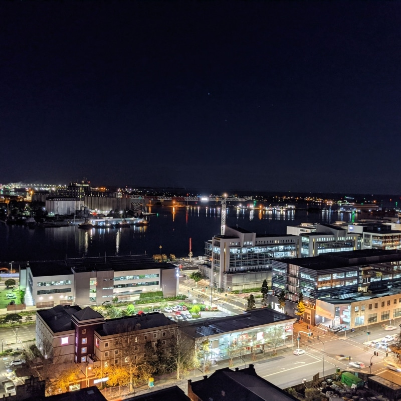 Vibrant urban nightscape showcasing smart infrastructure, lighting, and mixed-use zoning from Our Town Planning Process.