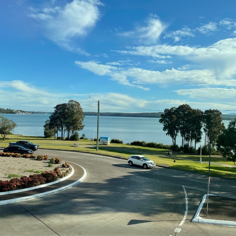 Roads, cars, lakefront park, and trees reflecting smart town planning in Lake Macquarie, NSW.