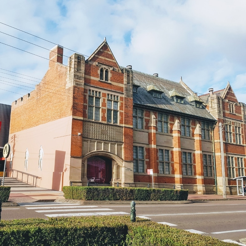 Historic brick building with Gothic architecture on main street, representing heritage aspects of Town Planning in Maitland